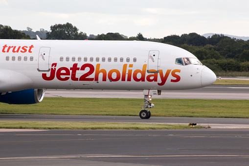 Manchester, United Kingdom - August 27, 2015: Jet2 Holidays Boeing 757 narrow-body passenger plane taxiing on Manchester International Airport taxiway after landing.