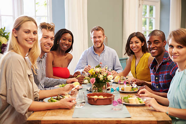 istock Friends At Home Sitting Around Table For Dinner Party 498918456