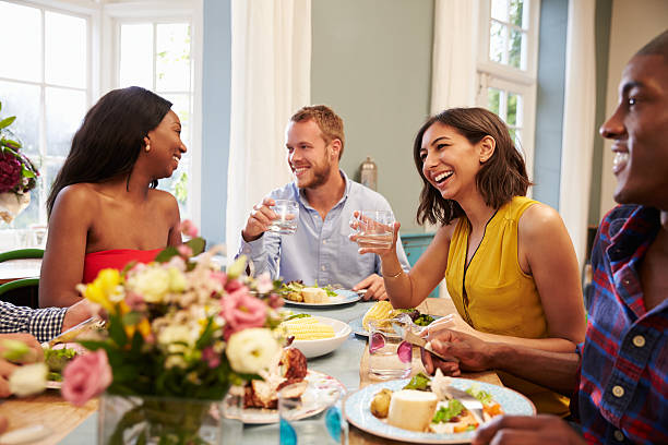istock Friends At Home Sitting Around Table For Dinner Party 498918562