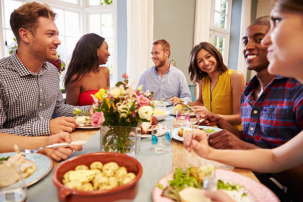 istock Friends At Home Sitting Around Table For Dinner Party 498918982
