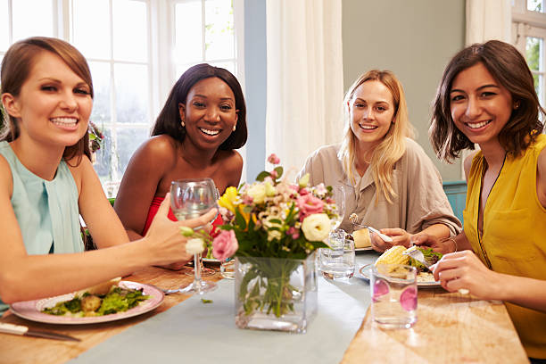 istock Female Friends At Home Sitting Around Table For Dinner Party 498919222