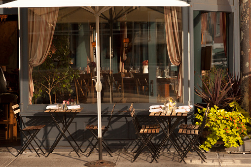 Cafe restaurant exterior with outdoor seating in the West Village neighborhood of downtown Manhattan, New York City. 