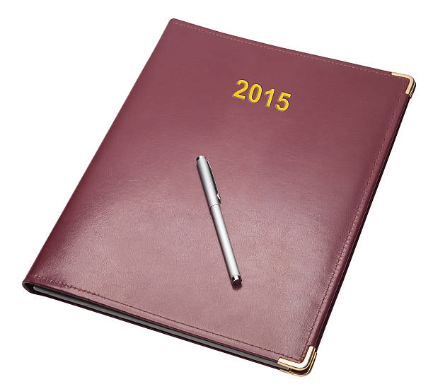 istock Burgundy 2015 note pad with pen, isolated 498920938