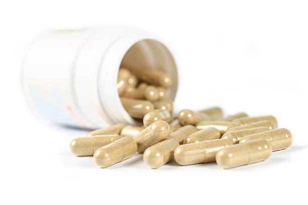 istock Herb capsule spilling out of a bottle 498924333