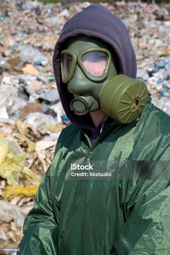 Man in a gas mask against polluted nature Man in a gas mask against polluted nature close up Accidents and Disasters Stock Photo