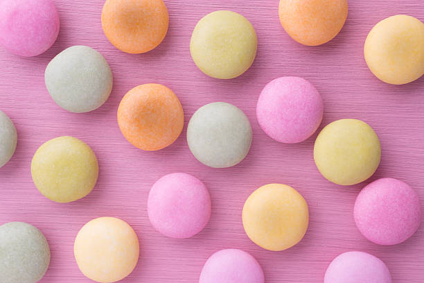 istock Colorful button candies against pink background 498924971