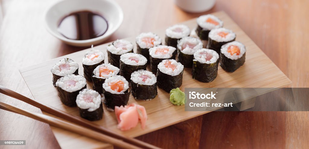 Sushi - Tuna and salmon maki roll. Sushi photo of a tuna and salmon maki roll. Arrangement Stock Photo