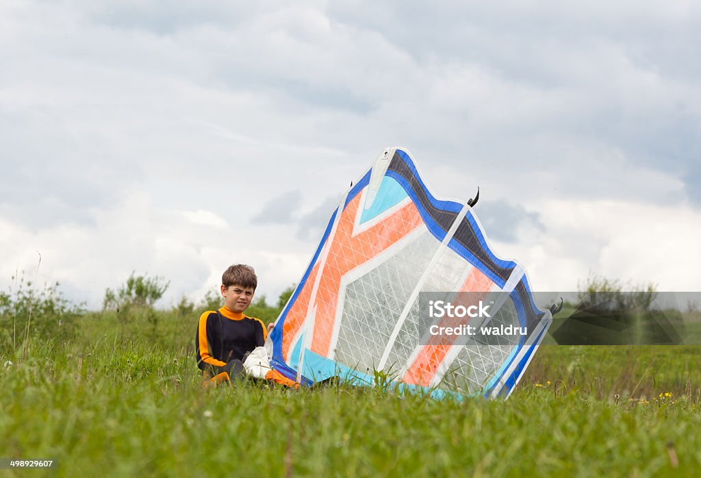 Young surfer Young surfer preparing windsurfing sail on the grass Aquatic Sport Stock Photo