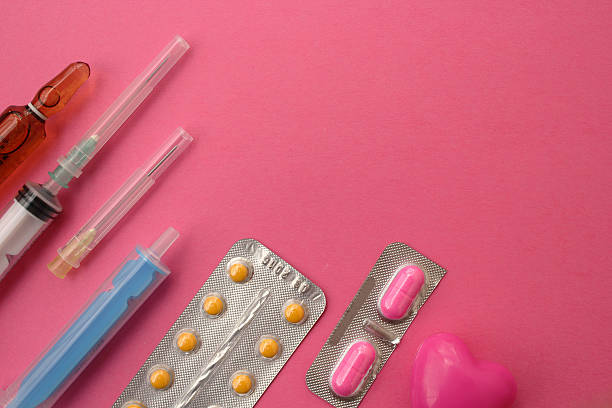 istock Syringe, needle and pills on pink background - medicine concept 498941154
