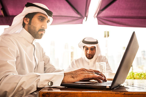istock Two Emirates business men filling documents in a cafe 498941822