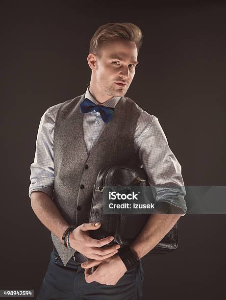 Handsome Elegant Man Wearing Bow Tie Holding Bag Stock Photo - Download Image Now - Briefcase, Millionnaire, 2015