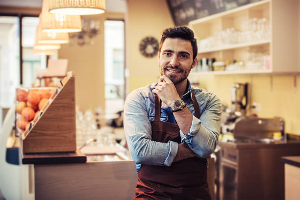 istock Young male cafe worker smiling at the camera 498942736