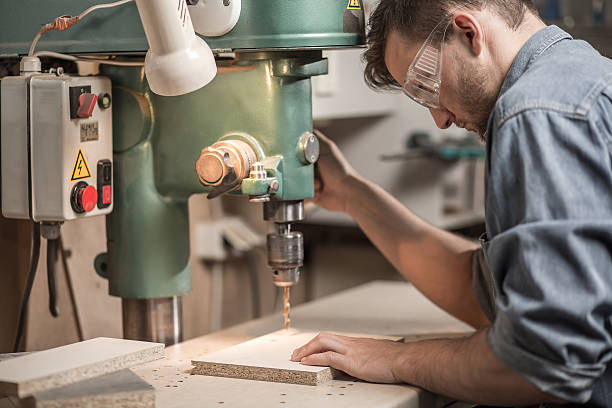istock Joiner drilling wooden board 498942788