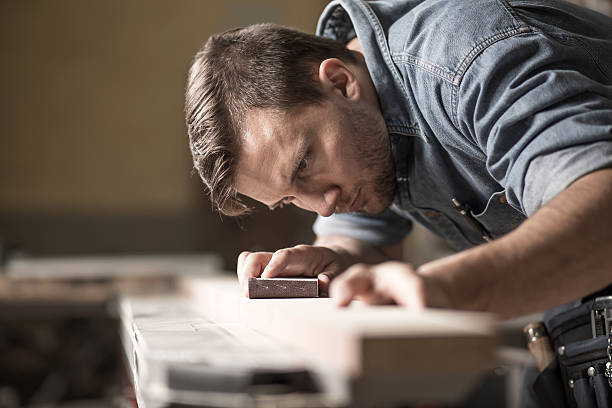 Cabinetmaker during work in workshop Portrait of handsome precise cabinetmaker during work in workshop carpenter portrait stock pictures, royalty-free photos & images