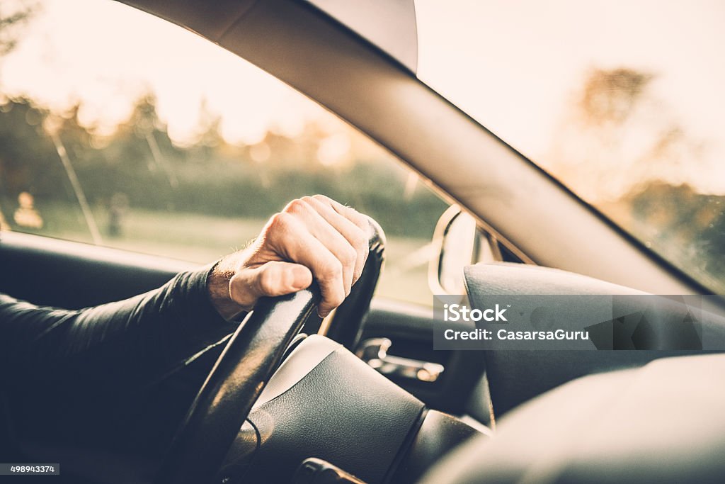 Portrait of a Young Man and his Car Man driving a car, close up on a steering wheel Car Stock Photo