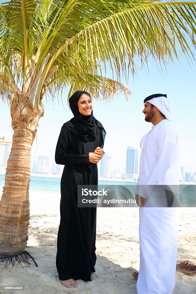 Arab family Middle Eastern couple standing in beach. Qatar Stock Photo