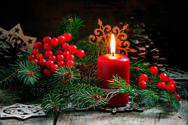 istock Christmas or New Year's dark composition with burning red candle 498945072