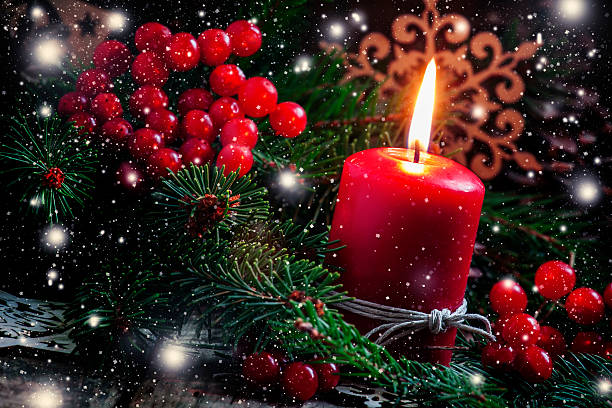 istock Christmas or New Year's dark composition with burning red candle 498945680