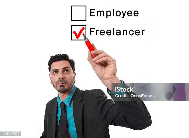 Businessman Choosing Freelancer To Employee Option Ticking Box With Marker Stock Photo - Download Image Now