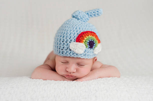 Newborn Baby Boy Wearing a Rainbow Hat stock photo
