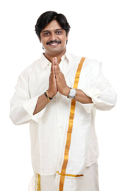 Happy traditional Indian young man gesturing isolated on white