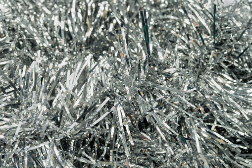 Garlands of silver christmas tree tinsel as a background