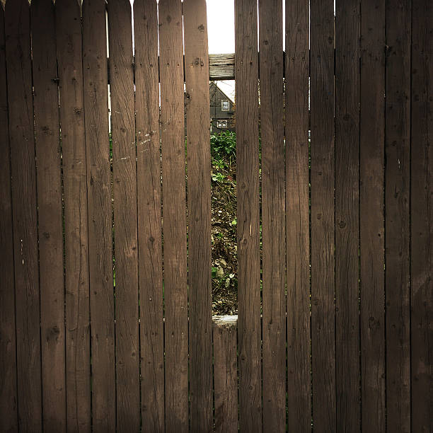 Gap in a wooden fence.