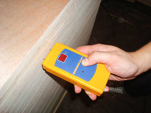 Worker Measuring the Level of Moisture Density for Quality Assurance stock photo