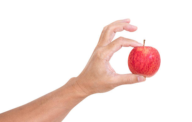 istock Man hand holding apple isolated on white background, clipping pa 498956975