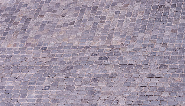 istock Old road paved with granite stones 498970740