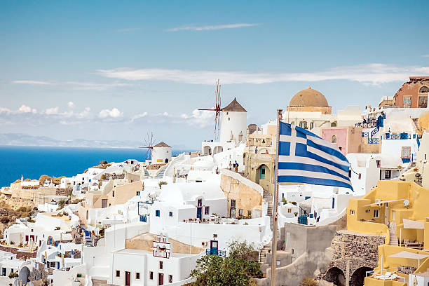 istock Scenic Santorini with Greek flag 498973508