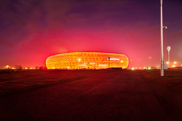 FC Bayern Munchen Stadium Munich, Germany - December 18, 2013: The football arena in Munich, Germany - special design and floated with white, red or blue light. The light depends on what kind of club is playing at night. This night was red time. allianz arena stock pictures, royalty-free photos & images