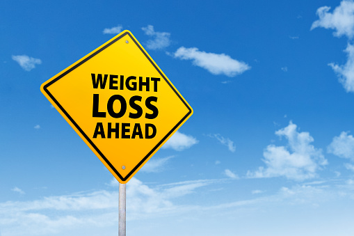 Signpost of weight loss under blue sky
