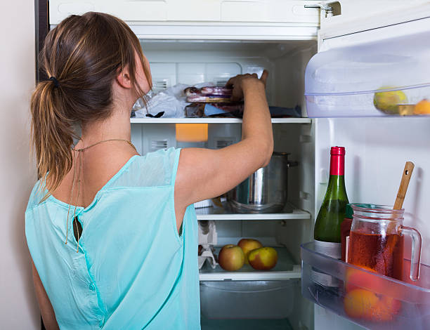 istock Woman near full fridge 498975676