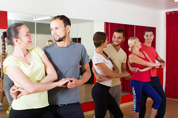 istock Group of people dancing salsa in studio 498975956