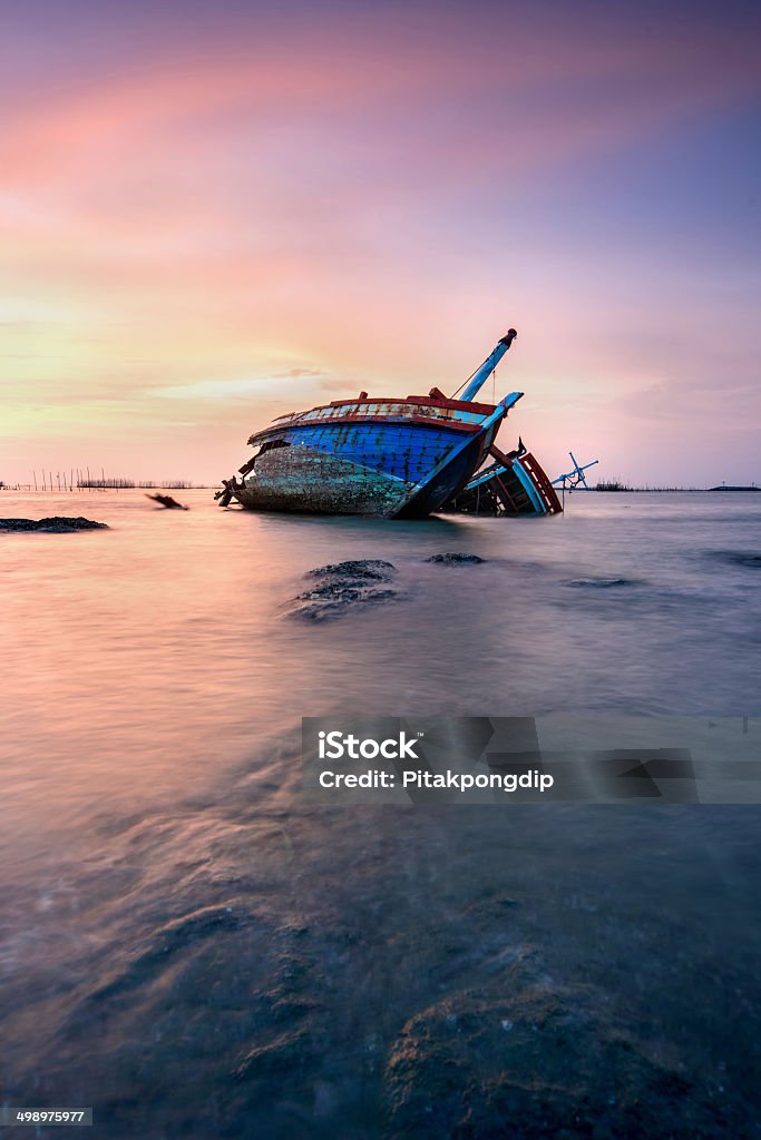 Thai Fisherman boat The old fisherman boat damage at sunset Chonburi Province Stock Photo