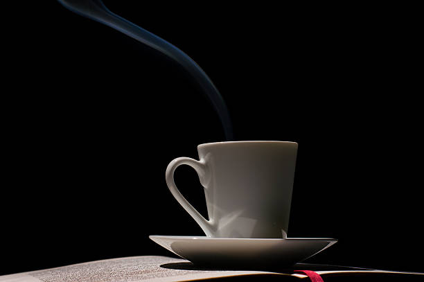 istock Espresso coffee cup with coffee beans with old book 498976319