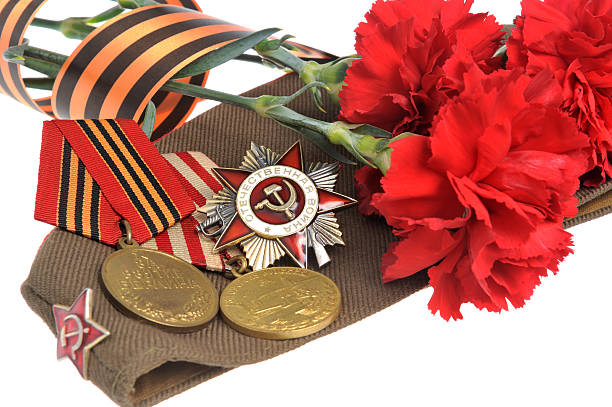 istock Soviet military cap with red flowers, Saint George ribbon, medal 498976727