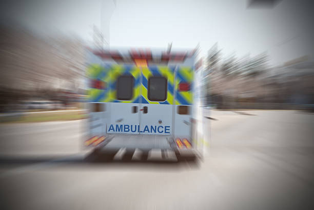 istock Ambulance on a call, rear view, zoom,selective focus 498977064