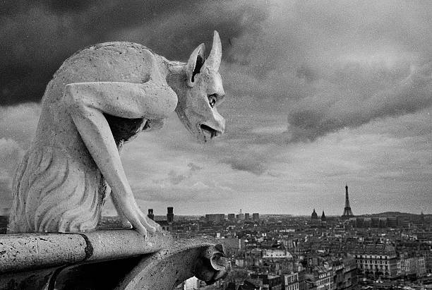 Paris, France - 09 24 2025: The towers of Notre-Dame Cathedral De Paris. View detail of an angel statue and the spire behind