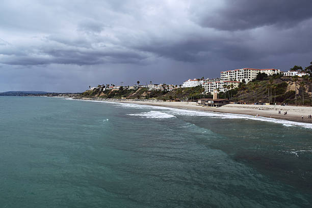 Stormy San Clemente, Southern California An El Nino rainstorm approaches San Clemente Beach on a beautiful sunny afternoon. el nino stock pictures, royalty-free photos & images