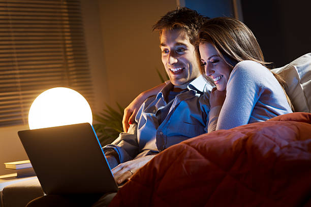 istock Young couple at home with laptop 498978693