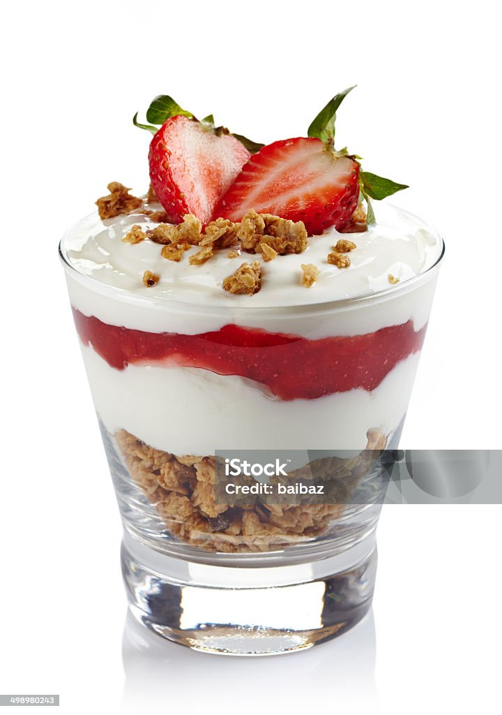 Layered cream dessert Healthy layered dessert with cream, muesli and fresh strawberry sauce isolated on white background Yogurt Stock Photo