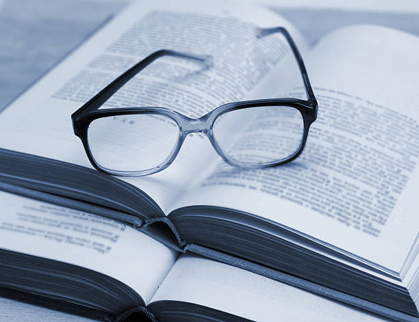 istock glasses and open books on the table 498980493