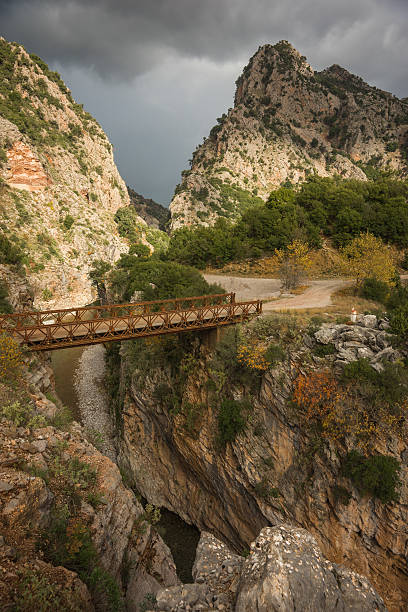 istock Scenic mountain autumn landscape with river and bridge 498983614