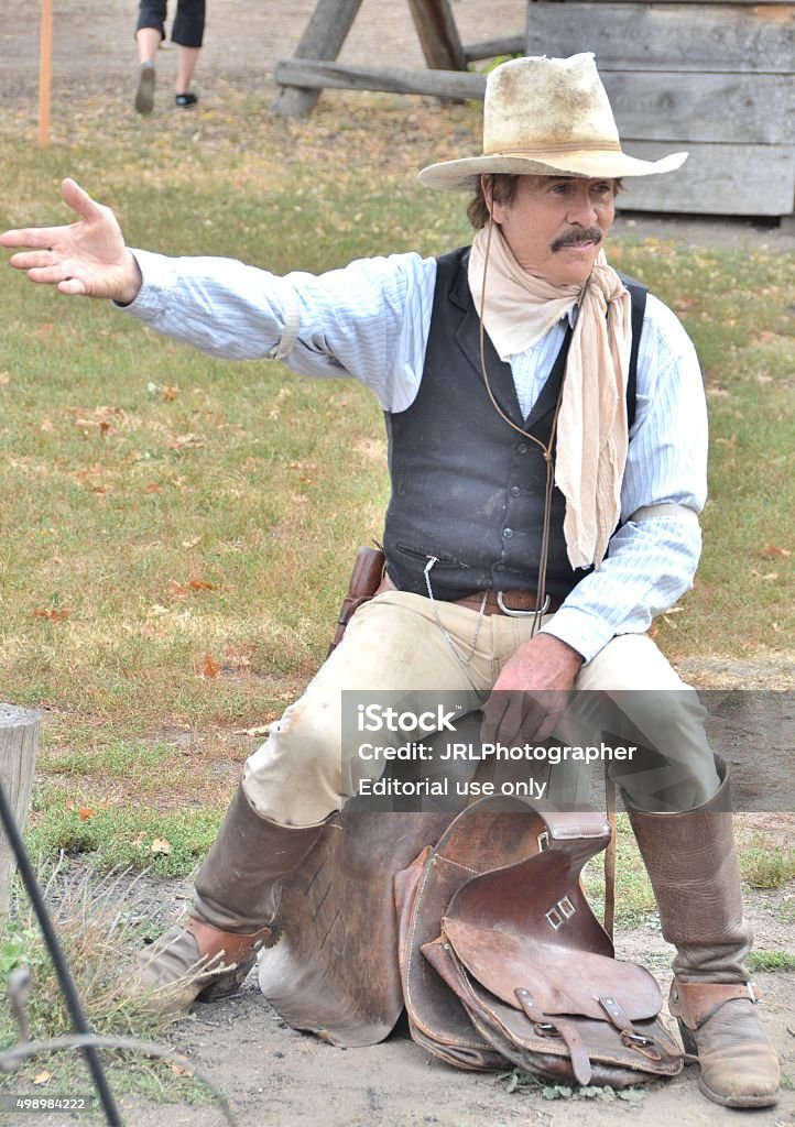 Cowboy Storyteller Denver, CO, USA - October 3, 2015: Denver's Four Mile Historic Park's annual family friendly Pumpkin Fall Festival. Open to all ages and both admission/parking are free! With old time music, homemade caramel apples, a pumpkin patch, crafts, a pie eating contest, horse drawn wagon rides and more there's sure to be something for everyone to enjoy!  2015 Stock Photo