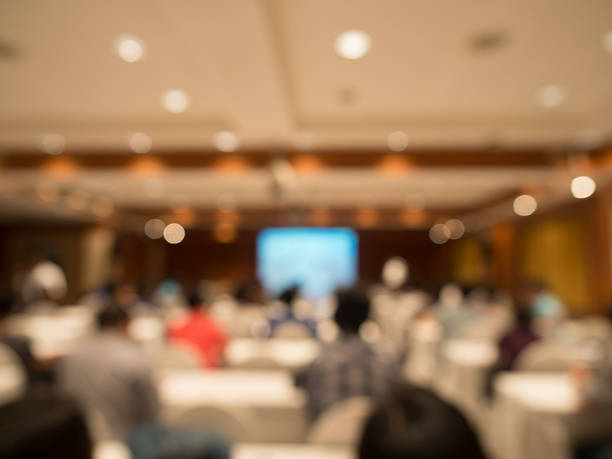 istock blurred people sitting rear at the business conference 498985322