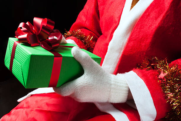 istock Santa Claus holding a gift 498993694