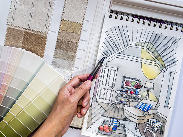 Interior designer's  hand working with illustration sketch and color samples stock photo