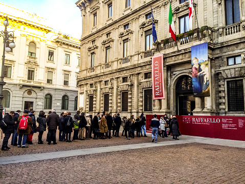 Milan, Italy  - December 25, 2014: People waiting in line to enter temporary Raffaello Exhibit, Milan